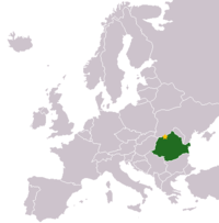 A map of Europe, all in grey, except for one green patch in the lower-right corner, and one small yellow dot on the green.