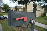 A grey United States Postal Service mailbox.
