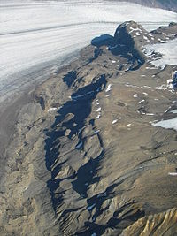 Dark rough rock explosed near a glacier.