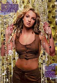 Image of a blond woman. She is wearing a brown top and brown pants. Her hair seems to be moving. The woman is looking directly into the camera. Her hands are against curtains of transparent jewels. The background is composed of dark yellow figures. In the upper left above the woman, the words 'BRITNEY SPEARS' are written in grey and violet handwriting with circles around. In the lower right of the image, the words "OOPS! I DID IT AGAIN TOUR 2000" are written in similar style.