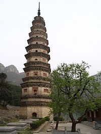 A thin, nine story tall octagonal pagoda. It is made of brown-orange brick and stone, and appears to lean slightly. Each floor is separated from the others by a double eave.