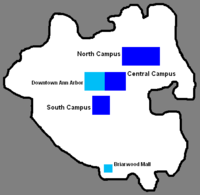 Black outline of city with three blues blocks in the center, one cyan block in the center, and one cyan block at the bottom inside the black outline