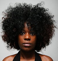 Woman wearing a loose Afro.