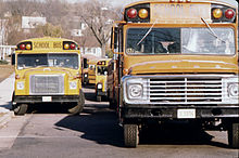 Two conventional school buses, from left to right: a Ward Volunteer with International Harvester chassis, and a Wayne conventional with Ford chassis, photographed in the mid-1970s.