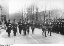Werner von Blomberg inspects a parade in his honor on his birthday. Soldiers with Guns stand to attention.
