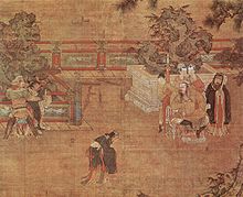 A painting of a play being staged in a courtyard. In the center, a man in loose black robes appears in mid-bow or mid-dance. To the left, two men dressed as guards are holding a third man, dressed in the same attire as the man in the center. To the right, a heavy set man sits in a throne. Behind him stand three women in white face paint and a man dressed in the same attire as the man in the center.