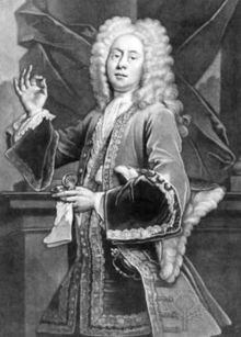 Interior scene of a young male actor in fine 17th century clothes, richly embroidered, wearing a full wig, holding up a pinch of snuff in his right hand between thumb and forefinger, with the snuffbox and handkerchief in his left hand.