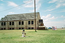 A large church with a decaying roof sits nearly alone in a small town in southwestern Oklahoma.