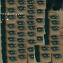 A portrait of replicated parts of a woman's blue eye. The parts are visible in a cut-out manner. The woman's full face becomes partially visible at the top right of the portrait. Centered in the left of the portrait in very small font is the names of the artists and song.