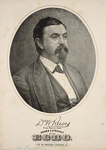 A heavyset, middle-aged man in formal wear with a thick mustache and goatee