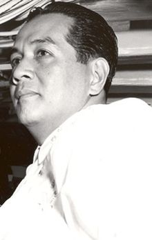 A black-and-white photograph of a middle-aged Filipino male, looking distantly toward the left of the image