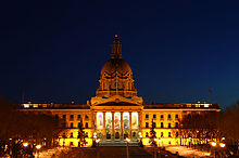Provincial Legislature of Alberta lit up by exterior lighting during a winter night.