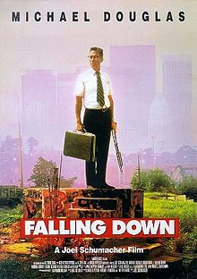 A poster depicting an older man standing on a concrete platform, wearing a business outfit, holding a briefcase and a shotgun. Above in black letters it reads: "Michael Douglas". Below in large white letters over a red background it reads: "Falling Down". Beneath that with the film credits, it reads in small white letters: "A Joel Schumacher Film". In the background are skyscrapers and a smog filled sky.