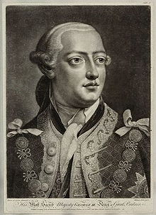 Head-and-shoulders monochrome portrait of a young clean-shaven man wearing a richly-patterned jacket, plain neckcloth, powdered wig, and the chain of office or livery collar of the Order of the Garter.