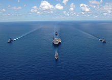 Four warships sailing alongside Washington