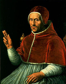 A middle-aged man in red and white clerical vestment.