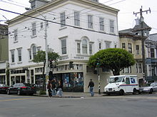  A color photo of a building with 'Haight' and 'Ashbury' signs on opposite sides of its corner