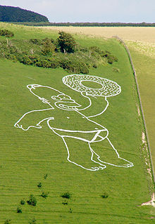 A man in his underpants holding a donut is drawn in white paint on a hill