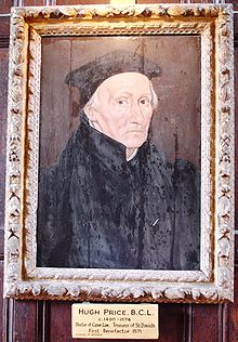 An elderly man in black robes and cap; the picture is in a decorated gold frame.