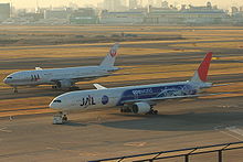 Two twin-engine airliners on parallel taxiways.