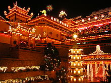 Temple at night illuminated with light from decorations