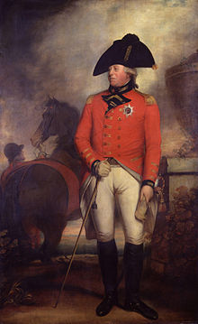 Clean-shaven man wearing the red jacket of an 1800 British army general with the star of the Order of the Garter, white breeches, black knee-high boots, and a black bicorne hat. Behind him a groom holds a horse.