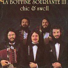 Photograph of La Bottine Souriante, posing with instruments