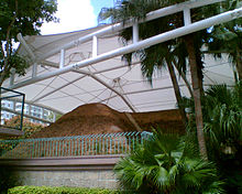 Outside view of an ancient tomb museum with protective canopy.