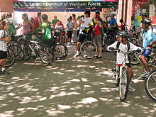 A group of people standing with their bicycles.