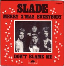 A monochrome photograph of four young men, with a white border, set almost centrally in a red square. The words "SLADE" dominate the cover, underneath which is written "MERRY X'MAS EVERYBODY". Underneath the photograph are the words "DONT BLAME ME". White stars border the left and right sides of the photograph.