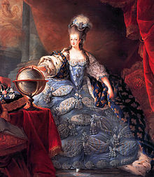 A woman with a pouf wears a voluminous blue dress with a train of fleur-de-lis.