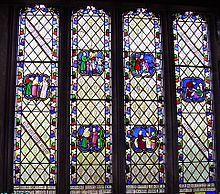 Photo of colourful stained class window showing human figures