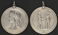 Two sides of a silver medal: the profile of Queen Victoria and the inscription "Victoria Regina" on one side, a man in European garb shaking hands with an Aboriginal with the inscription "Indian Treaty 187" on the other