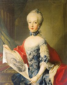 A young blue-eyed girl wears a blue rococo bodice with frilled sleeves while holding a portrait of her father.