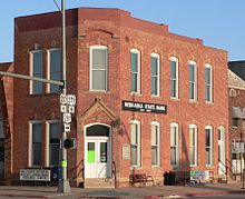 Two-story brick building; sign reading "Nebraska State Bank"; sign reading "Holt County Historical Museum and Genealogical Research Center"