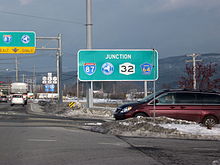 A big green sign reads "Junction I-87, New York Thruway, NY 32, and Orange County Route 64".