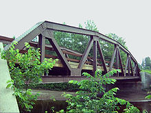 A relatively small steel bridge seen from the side.