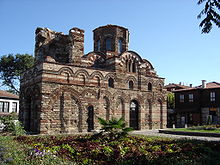 A well-preserved elongated Byzantine-style church with lavish decoration featuring blind arches and ceramics