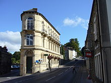 Italianate three storey building, with entrance at the narrow end of the building nearest the camera