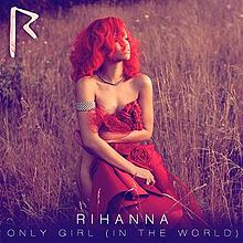 Rihanna is kneeling, alone in the middle of a field. She is looking off into the distance. She is naked, covering herself with a a red fabric. In the top left corner, there is a jagged pink "R". At the bottom, there are two lines of thin, centered text. In all capital letters, they read, "Rihanna: 'Only Girl (In the World)'."