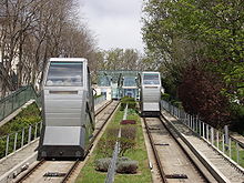 A photograph looking up the railway, showing the two tracks receding into the distance and two cabins, one nearer than the other
