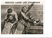 two women putting on hockey equipment