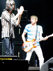 Two people (one vocalist and one guitarist) performing on stage