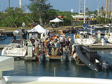 A docking bay filled with boats and people.