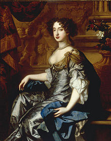 portrait of a woman with brown hair in a blue-and-gray dress