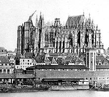 Old photo of the cathedral before completion shows the east end finished and roofed, while other parts of the building are in various stages of construction.