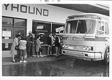 Passengers mounting bus at Greyhound bus station