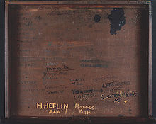 Inside of wooden desk with several names carved into it