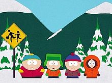Screenshot from an animated show: Against a background of snowy mountains and trees, four boys stand and wait at a school bus stop