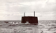 Port side view of the sail and forward deck of the nuclear submarine Triton breaking the surface of the ocean near Cadiz, Spain, with hull number 586 visible on its sail.